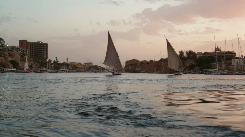 Feluccas under sail on the Nile as the light turns