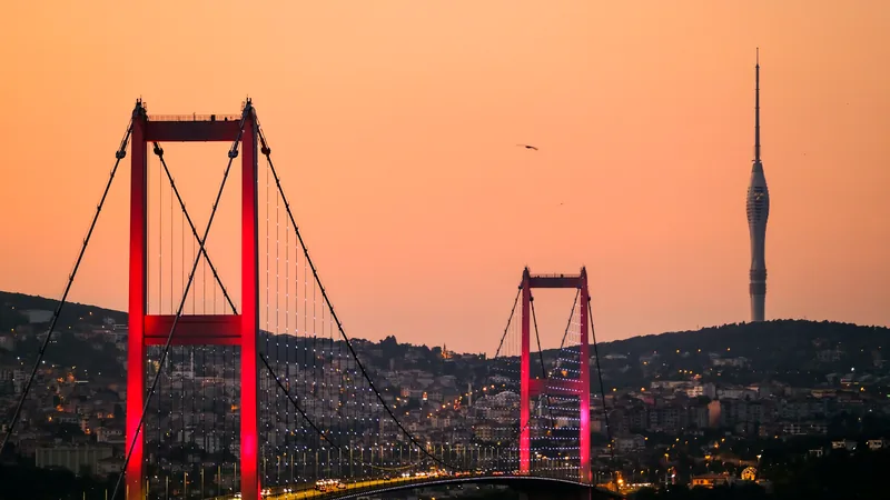 The suspension towers of the Bosphorus bridge against a warm evening sky