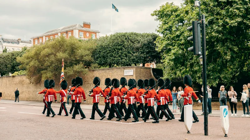 Guards in red tunics marching near Buckingham Palace