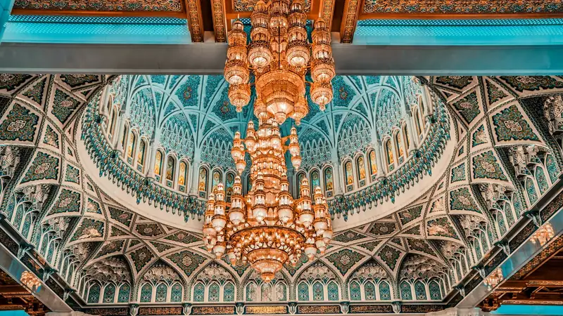 The painted dome and vast chandelier inside the Sultan Qaboos Grand Mosque